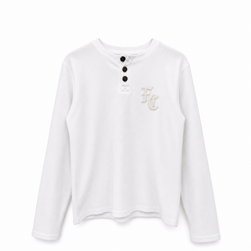A white long-sleeve henley shirt with three black buttons at the collar and a small beige embroidered 'FC' monogram on the left chest, shown against a plain white background.