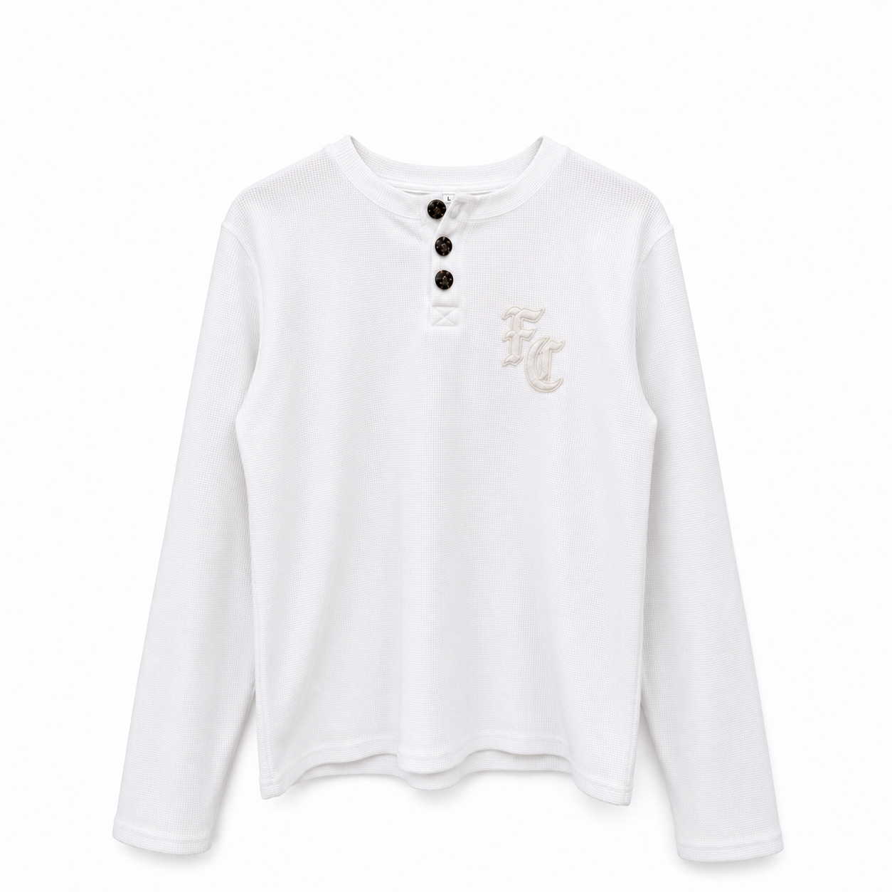 A white long-sleeve henley shirt with three black buttons at the collar and a small beige embroidered 'FC' monogram on the left chest, shown against a plain white background.